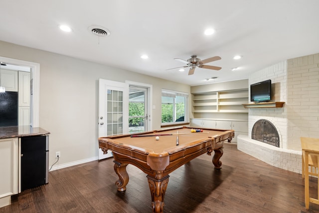 recreation room with hardwood / wood-style flooring, a fireplace, brick wall, ceiling fan, and billiards