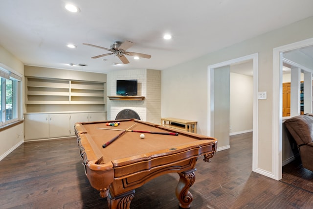 rec room featuring dark wood-type flooring, ceiling fan, a brick fireplace, brick wall, and billiards