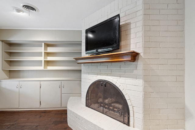 living room with ornamental molding, a fireplace, and dark hardwood / wood-style floors