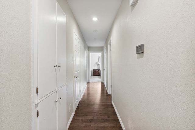 hallway featuring dark wood-type flooring