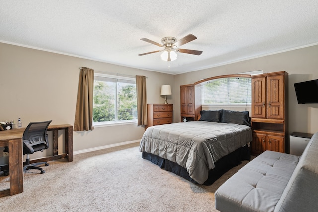 bedroom with crown molding, a textured ceiling, light colored carpet, and ceiling fan