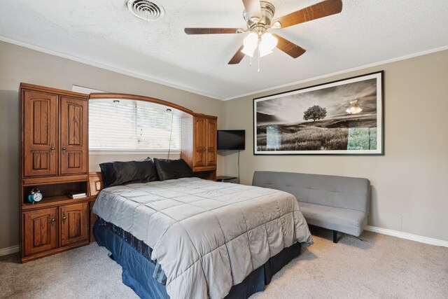 carpeted bedroom with crown molding and ceiling fan