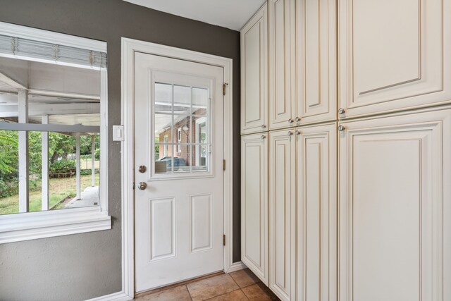 entryway featuring light tile patterned floors and plenty of natural light