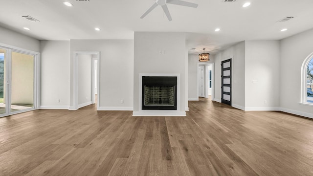 unfurnished living room featuring wood-type flooring and ceiling fan