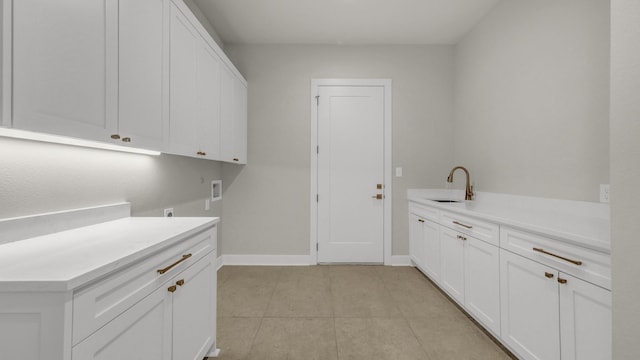 washroom with sink, cabinets, light tile patterned floors, hookup for a washing machine, and electric dryer hookup