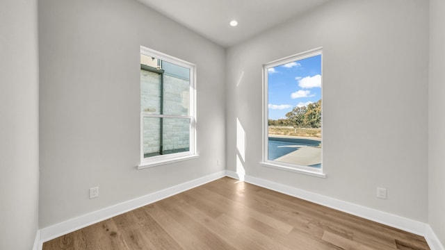 unfurnished room featuring hardwood / wood-style flooring