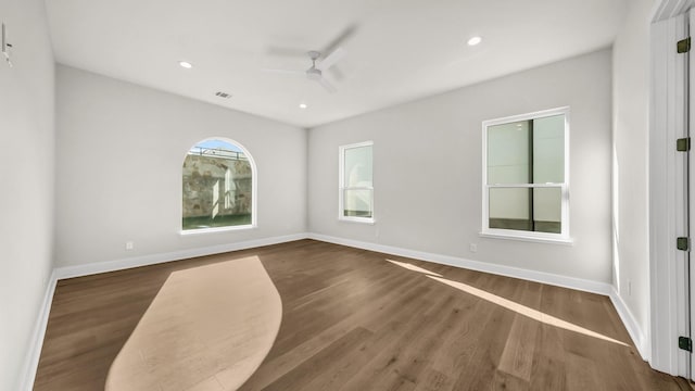 unfurnished room featuring dark hardwood / wood-style floors and ceiling fan