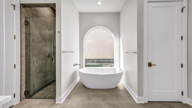 bathroom featuring separate shower and tub