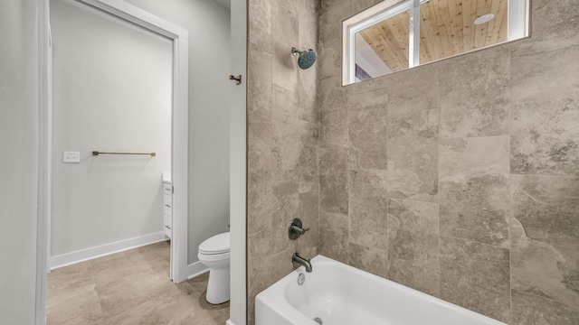 full bathroom with tiled shower / bath, vanity, and toilet