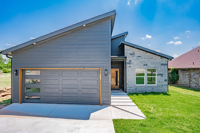 contemporary home featuring a garage and a front yard