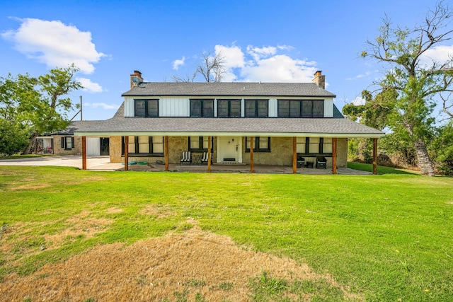 farmhouse-style home with a patio and a front lawn