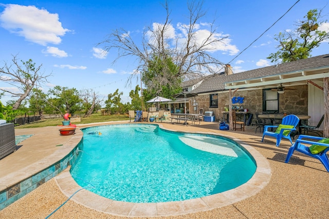 view of pool with a patio and ceiling fan