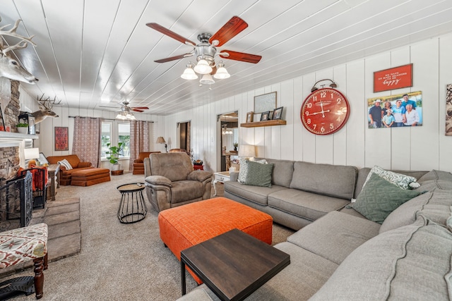 carpeted living room with ceiling fan