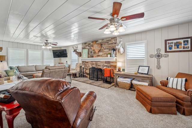 carpeted living room featuring a fireplace, a wealth of natural light, and ceiling fan