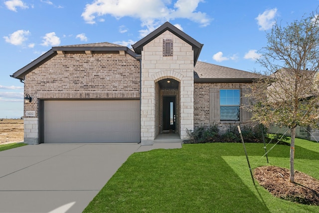 view of front facade with a garage and a front lawn