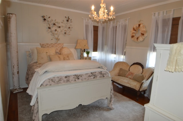 bedroom with hardwood / wood-style flooring, crown molding, and a chandelier