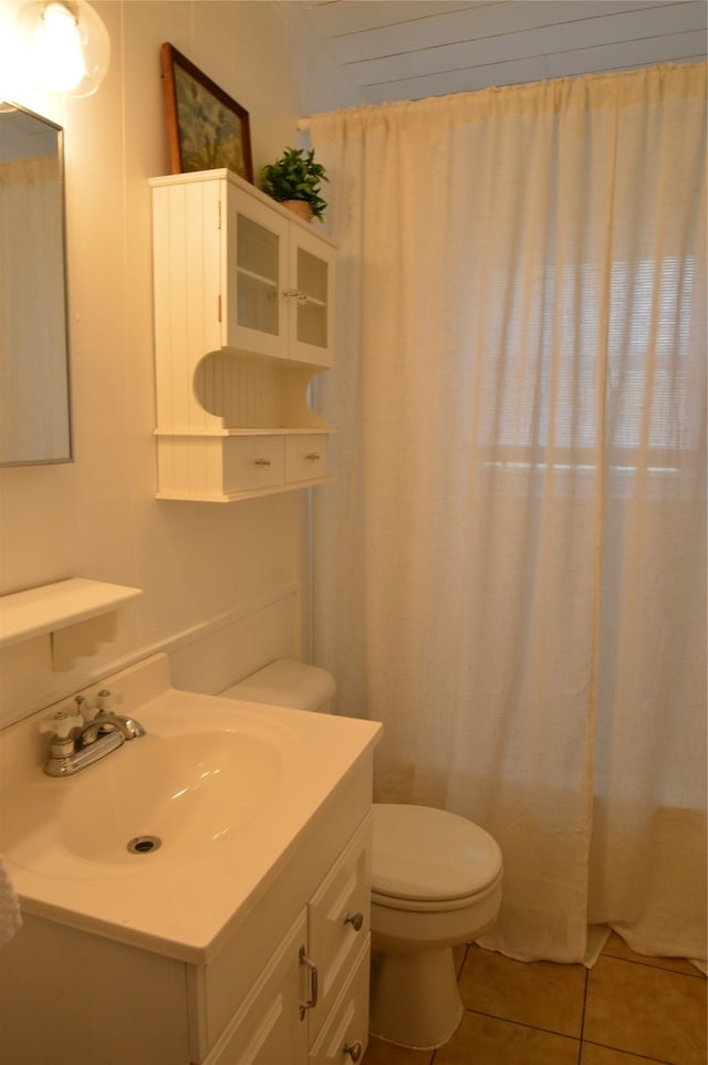 bathroom with tile patterned floors, vanity, and toilet