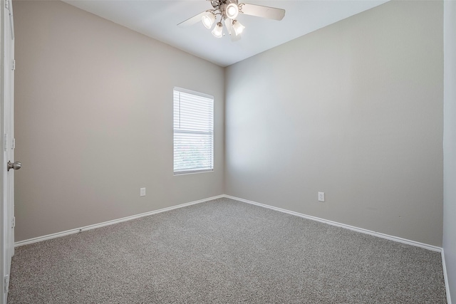 empty room with baseboards, carpet floors, and a ceiling fan