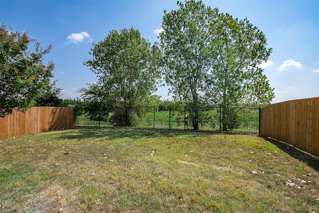 view of yard with a fenced backyard