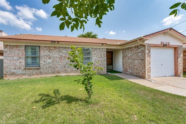 ranch-style home with a garage and a front yard