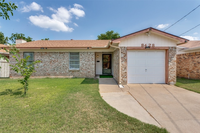 single story home with a garage and a front lawn