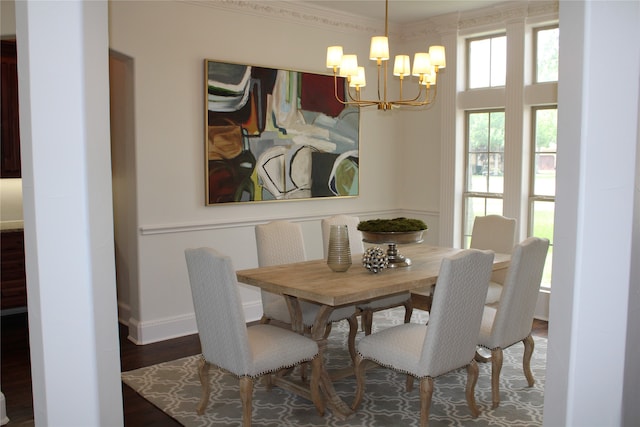 dining space with plenty of natural light, a chandelier, crown molding, and wood-type flooring