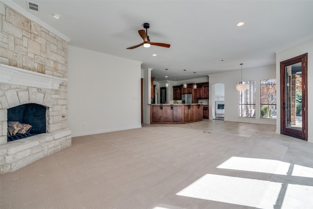 living room featuring a fireplace, light carpet, ceiling fan, and ornamental molding