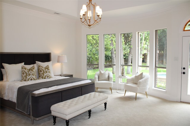 carpeted bedroom featuring crown molding and an inviting chandelier