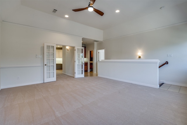 interior space with light carpet and ceiling fan