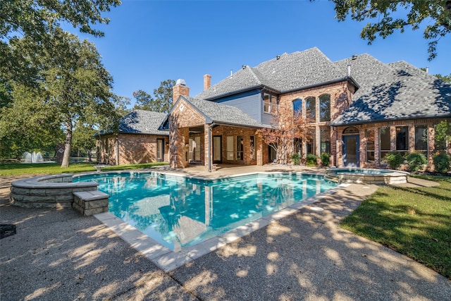 view of pool featuring a patio area and an in ground hot tub