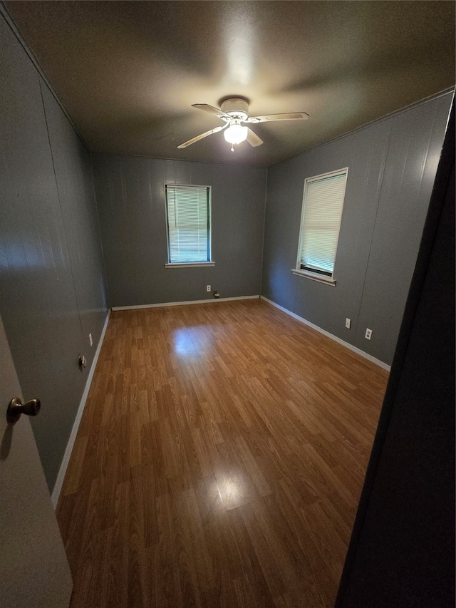 spare room featuring ceiling fan and wood-type flooring