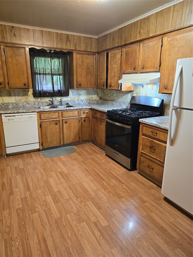 kitchen with crown molding, light hardwood / wood-style flooring, white appliances, and sink