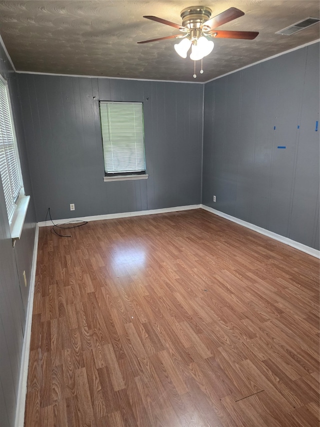 spare room with wood-type flooring and ceiling fan