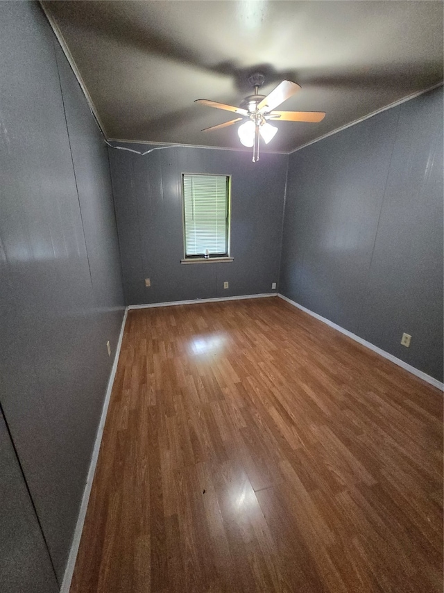 spare room featuring wood-type flooring and ceiling fan