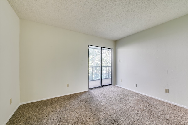 unfurnished room featuring carpet floors and a textured ceiling