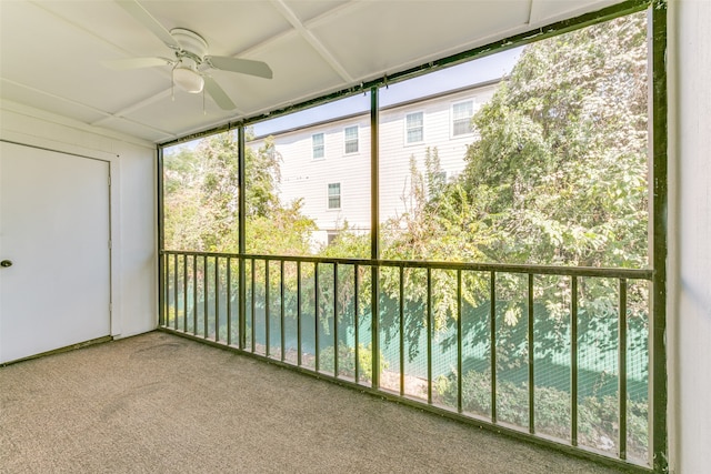 unfurnished sunroom with a water view and ceiling fan