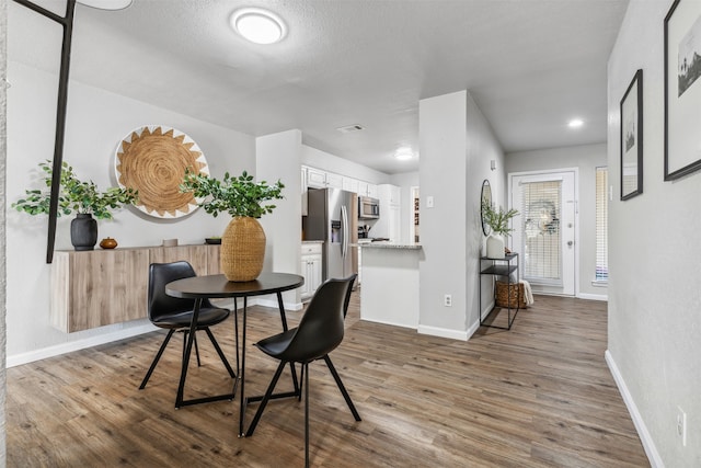 dining room with wood-type flooring