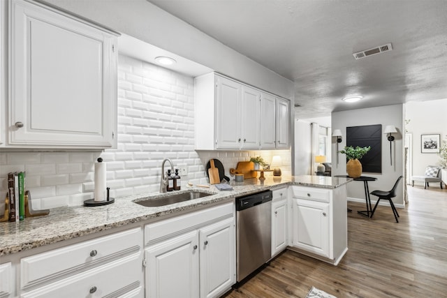 kitchen featuring sink, dishwasher, dark hardwood / wood-style flooring, and white cabinets