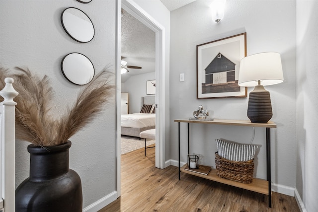 corridor featuring hardwood / wood-style floors and a textured ceiling