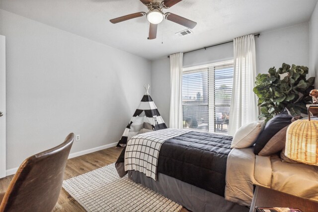 bedroom with wood-type flooring and ceiling fan