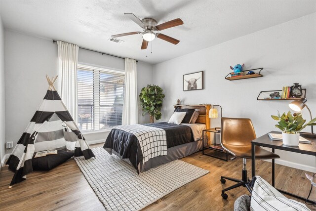 bedroom with wood-type flooring and ceiling fan