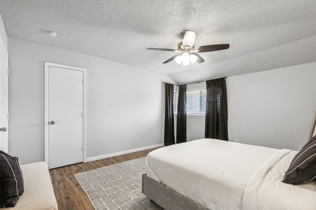 bedroom featuring a textured ceiling, wood-type flooring, and ceiling fan