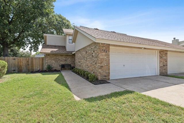 view of home's exterior featuring a garage and a lawn