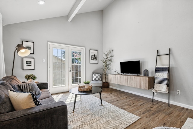 living room with hardwood / wood-style flooring, beamed ceiling, french doors, and high vaulted ceiling