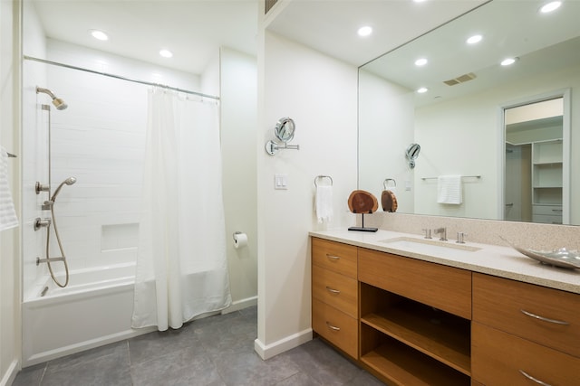 bathroom with vanity, shower / bathtub combination with curtain, and tile patterned floors