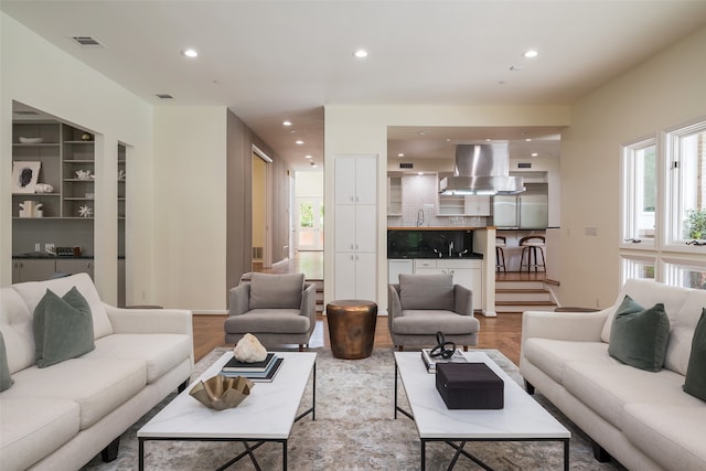 living room with wood-type flooring and sink