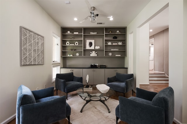 sitting room with hardwood / wood-style flooring and ceiling fan