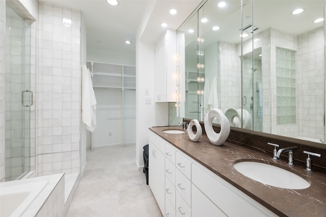 bathroom featuring plus walk in shower, tile patterned flooring, and dual bowl vanity