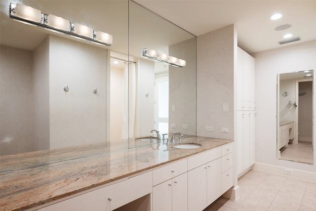 bathroom featuring tile patterned flooring and vanity