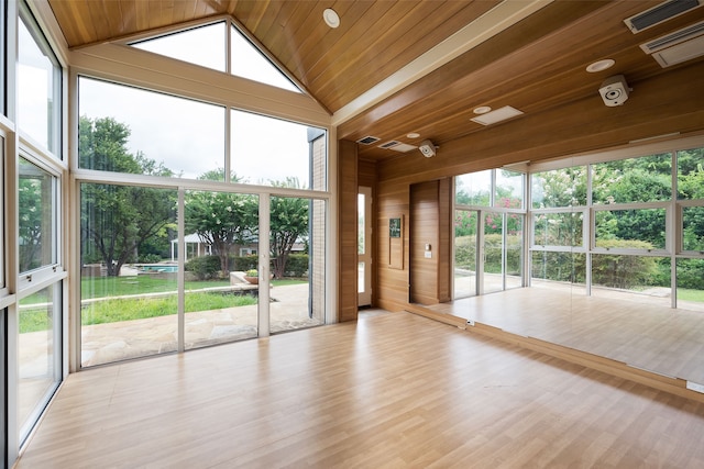 unfurnished sunroom featuring vaulted ceiling and wooden ceiling